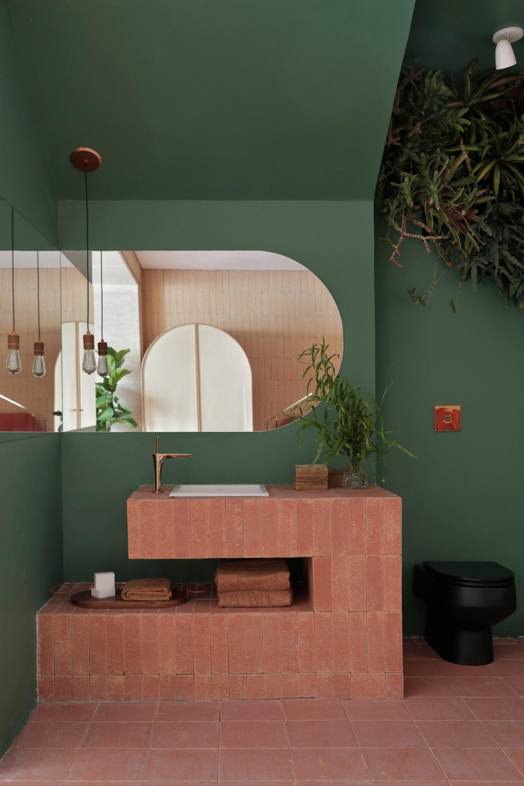 Dark green tiled shower room with wooden vanity